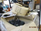 a pile of boxes and a box of screws on a table