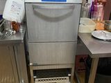 a dishwasher in the middle of a kitchen with a lot of dishes on the counter