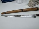 a knife and a knife sharper on a table
