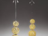 a pair of yellow glass lamps with metal bases