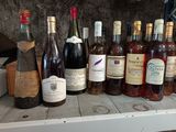 many bottles of wine sitting on a shelf next to each other