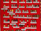 a red display case filled with lots of different types of buttons