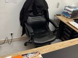 a desk with a chair and a computer on it