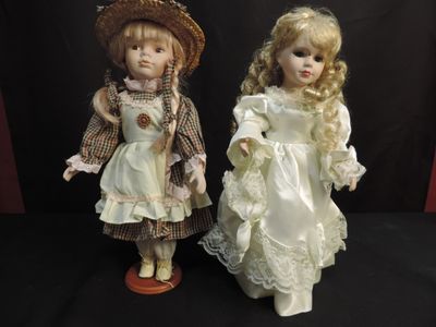 two dolls that are standing next to each other