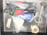 a metal box filled with various tools and supplies