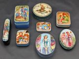 many different tins with pictures on them on a table