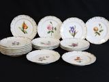 a lot of plates with flowers on them on a table