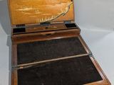 a small wooden box with a mirror on top of it