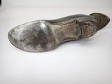 an image of a pair of silver shoes sitting on top of a white surface
