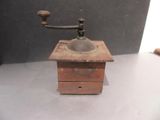 an old coffee grinder sitting on a table