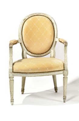 an upholstered chair with a beige upholstered seat and a beige upholstered back