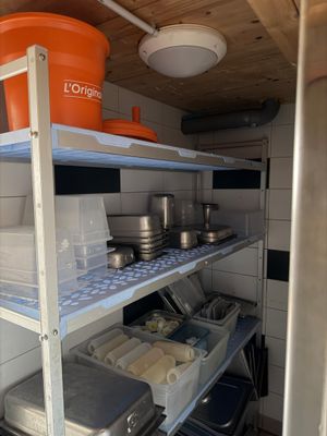 shelves with pots and pans on them in a small kitchen
