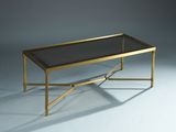 a gold coffee table with a glass top and metal legs