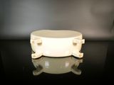 a white bowl sitting on top of a black table