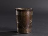 a metal cup that is sitting on a table