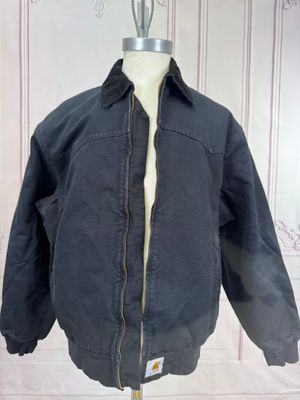 jacket on a mannequin stand in front of a white wall