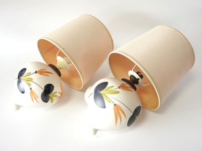 three cups that have been decorated with flowers on them