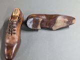 pair of men ' s brown leather shoes with laces on them