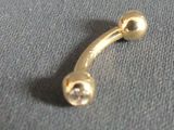 a gold nose ring with a diamond on it