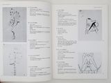 a person holding a book with drawings on it