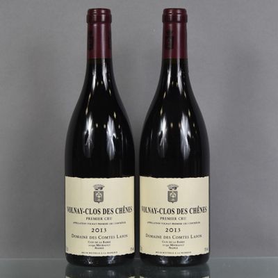 two bottles of red wine sitting on top of a glass table