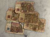 several pieces of paper money sitting on top of a marble counter