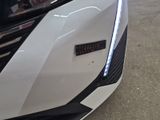 a close up of a white car with a sticker on the front of it