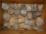 a wooden box filled with rocks on a table