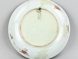 an image of a white plate with a gold rim on a gray surface