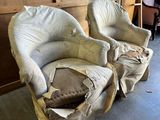 two chairs that are covered with a sheet of paper