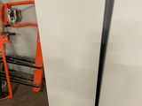 two white refrigerators in the garage next to each other