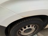 a close up of a tire on a white car