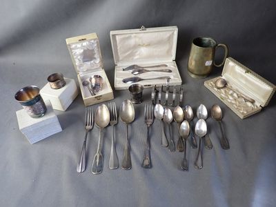 a lot of silver spoons and spoons on a table
