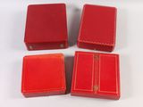 three small red boxes are sitting next to each other on a white surface