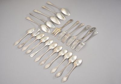 a group of silver spoons and forks arranged on a table