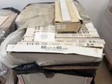 a pile of boxes sitting on a pallet in the middle of a room