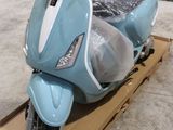 un scooter posé sur une boîte posée par terre