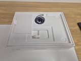 a white box that has a charger and a remote on it