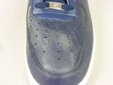 a close up of a pair of blue shoes on a white surface