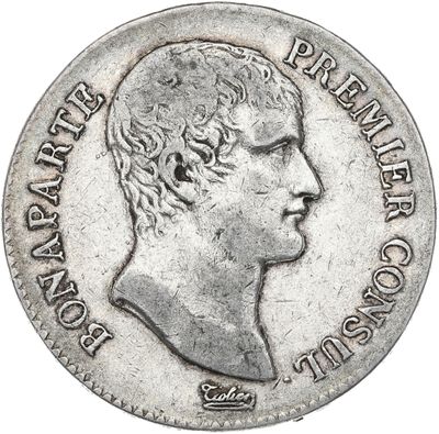 Gros plan sur une pièce de monnaie portant le visage d'un homme
