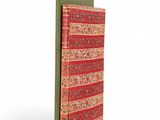 a red and green book with a striped cover