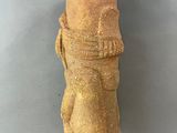 an ancient statue of a man with a hat on it ' s head