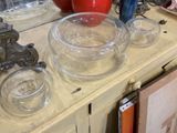many glass bowls and bowls on a table