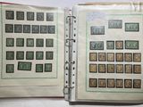 an open book with stamps on it on a table