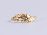 an image of a gold ring with two diamonds