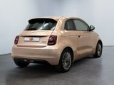 the back of a beige car is parked in a white room