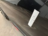 a sticker on the hood of a car that is parked on the side of the road