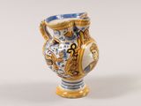 a blue and white vase sitting on a white surface