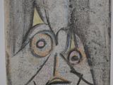 a picture of a painting of a face on the wall