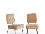 pair of mid - century chairs with upholstered backrests and metal legs